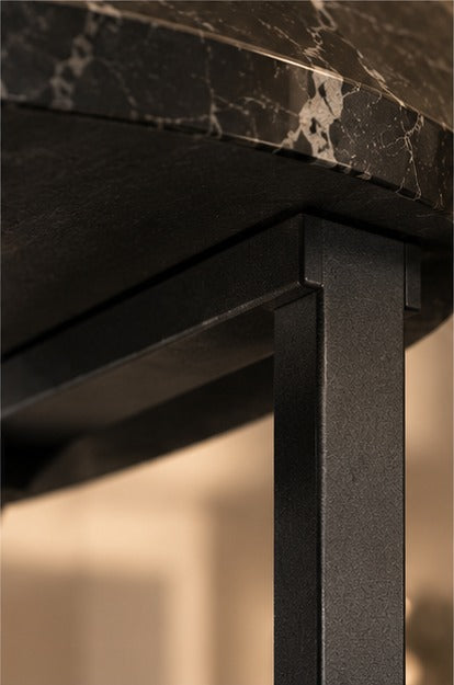 Where the smaller table meets the larger one's frame