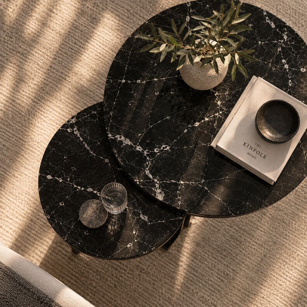 Both tables seen from above, with a vase, a book and a glass